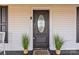 Front entrance with decorative stained glass door flanked by ornamental plants and stylish black shutters at 34 Lee Rd, Stony Point, NC 28678