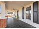 Inviting front porch with black painted floors, ceiling fan, and ornamental plants at 34 Lee Rd, Stony Point, NC 28678