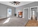 Open living room with fireplace, ceiling fan, and large window at 34 Lee Rd, Stony Point, NC 28678