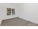 Simple bedroom with carpeted floor and large window at 3524 Cloninger Rd, Dallas, NC 28034