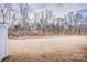 Landscaped backyard with a view of trees at 3936 Rothwood Ln, Harrisburg, NC 28075