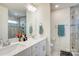 Elegant bathroom with dual vanity and a large mirror at 3936 Rothwood Ln, Harrisburg, NC 28075