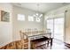 Charming dining area with wooden table and bench near sliding door at 3936 Rothwood Ln, Harrisburg, NC 28075