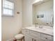 Clean half bathroom with white vanity and large mirror at 3936 Rothwood Ln, Harrisburg, NC 28075