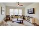 Living room with hardwood floors, beige sofa, and large windows at 3936 Rothwood Ln, Harrisburg, NC 28075