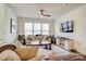 Living room with hardwood floors, beige sofa, and large windows at 3936 Rothwood Ln, Harrisburg, NC 28075