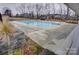 Community swimming pool with surrounding landscaping at 3936 Rothwood Ln, Harrisburg, NC 28075