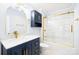 Modern bathroom with navy vanity, gold fixtures, and a tub at 404 Ford St, Kannapolis, NC 28083