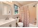 Bright bathroom features modern fixtures, vanity, and shower with decorative curtain at 4145 Wall St, Charlotte, NC 28209