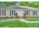 Charming home with updated landscaping, stone accents, and a well-manicured lawn leading to the front entrance at 4145 Wall St, Charlotte, NC 28209