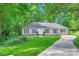 Charming home featuring a lush green lawn, complemented by mature trees and a well-maintained landscape at 4145 Wall St, Charlotte, NC 28209