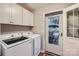 Well-equipped laundry room with modern washer, dryer, and ample cabinet storage at 4145 Wall St, Charlotte, NC 28209