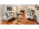 Inviting living room featuring hardwood floors, a cozy seating arrangement, and a decorative fireplace at 4145 Wall St, Charlotte, NC 28209