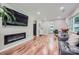 Modern living room featuring hardwood floors, an electric fireplace, and comfortable seating at 4145 Wall St, Charlotte, NC 28209