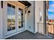 A home's charming balcony features a decorative exterior light and glass doors at 425 Delburg Mill Alley Dr, Davidson, NC 28036