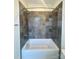 Bathroom featuring a tub and gray tiled shower at 425 Delburg Mill Alley Dr, Davidson, NC 28036