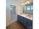 Bathroom featuring double sinks, vanity with stone countertops, and modern fixtures at 425 Delburg Mill Alley Dr, Davidson, NC 28036