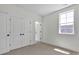 Bright bedroom featuring neutral carpet, a window for natural light and large closets for plenty of storage at 425 Delburg Mill Alley Dr, Davidson, NC 28036