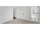 Bright bedroom featuring neutral carpet, double closets, and a full bathroom, creating a calm and inviting space at 425 Delburg Mill Alley Dr, Davidson, NC 28036