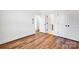 Spacious bedroom featuring sleek wood floors, double closets, and ensuite bath for a luxurious retreat at 425 Delburg Mill Alley Dr, Davidson, NC 28036