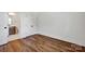 Elegant bedroom featuring sleek wood floors, a ensuite bath, and large closets for ample storage at 425 Delburg Mill Alley Dr, Davidson, NC 28036