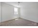 Cozy bedroom with neutral carpet, a window for natural light, offering a blank canvas to create your dream space at 425 Delburg Mill Alley Dr, Davidson, NC 28036