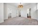 Carpeted primary bedroom with a modern chandelier, walk-in closet and ensuite bathroom at 425 Delburg Mill Alley Dr, Davidson, NC 28036