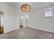 Cozy carpeted bedroom featuring a modern light fixture and ample natural light at 425 Delburg Mill Alley Dr, Davidson, NC 28036