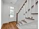 Inviting entryway featuring a wood floor, staircase, and a glass-paneled front door at 425 Delburg Mill Alley Dr, Davidson, NC 28036
