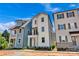 This is a two-story home with a balcony and porch, nestled between neighboring houses at 425 Delburg Mill Alley Dr, Davidson, NC 28036