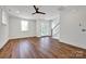 Bright, spacious living room with sleek wood floors, staircase and large windows at 425 Delburg Mill Alley Dr, Davidson, NC 28036