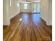 Bright living room with hardwood floors, large windows, and modern ceiling fan at 425 Delburg Mill Alley Dr, Davidson, NC 28036