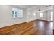 Bright living room featuring sleek wood floors, large windows, and modern, neutral paint at 425 Delburg Mill Alley Dr, Davidson, NC 28036