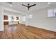 Open-concept living room with sleek wood floors and view of kitchen at 425 Delburg Mill Alley Dr, Davidson, NC 28036