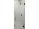 White tiled shower with glass enclosure and bronze hardware at 425 Delburg Mill Alley Dr, Davidson, NC 28036