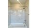 Bright bathroom showcasing a tiled shower-tub combination with white marble-look tiling at 429 Delburg Mill Alley Dr, Davidson, NC 28036