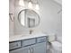 Stylish bathroom with a marble-look shower, vanity with blue cabinets, and modern fixtures at 429 Delburg Mill Alley Dr, Davidson, NC 28036