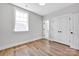 Comfortable bedroom with natural light, wooden floors, and a double door closet providing storage at 429 Delburg Mill Alley Dr, Davidson, NC 28036