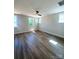 Bright and spacious bedroom featuring hardwood floors, a ceiling fan, and plenty of natural light at 429 Delburg Mill Alley Dr, Davidson, NC 28036