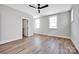 Bright bedroom featuring a ceiling fan, wood-look floors, and natural light from the dual windows at 429 Delburg Mill Alley Dr, Davidson, NC 28036