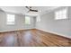 Spacious bedroom features hardwood floors, multiple windows, and a ceiling fan at 429 Delburg Mill Alley Dr, Davidson, NC 28036