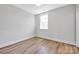 Cozy bedroom with neutral walls, wooden floors, and ample natural light, creating a welcoming space at 429 Delburg Mill Alley Dr, Davidson, NC 28036
