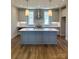 Modern kitchen featuring a large island, stainless steel appliances, and stylish pendant lighting at 429 Delburg Mill Alley Dr, Davidson, NC 28036