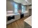 Stylish kitchen with stainless steel appliances, light cabinetry, and light countertops at 429 Delburg Mill Alley Dr, Davidson, NC 28036