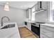 This kitchen is equipped with stainless steel appliances, light gray cabinets, and modern countertops at 429 Delburg Mill Alley Dr, Davidson, NC 28036