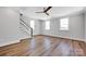 Bright living room features hardwood floors, lots of natural light, and a staircase at 429 Delburg Mill Alley Dr, Davidson, NC 28036