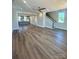 Open-concept living room featuring new vinyl flooring and a stairway at 429 Delburg Mill Alley Dr, Davidson, NC 28036