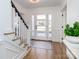 Light-filled entryway with hardwood floors, staircase, and front door view at 4342 Arborway None, Charlotte, NC 28211