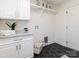 Laundry room with white cabinets, hexagon tile floor, and shelving at 4342 Arborway None, Charlotte, NC 28211