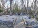 Landscaped backyard with fire pit and bridge at 4440 Beechaven Dr, Rock Hill, SC 29732